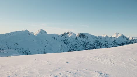 slow pan to the left of the snow filled canadian rockies in winter at sunset