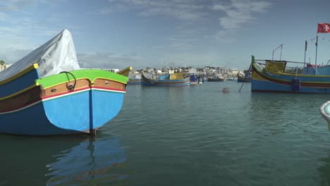 traditional fishing boats in the harbour of fishing village of marsaxlokk in malta island