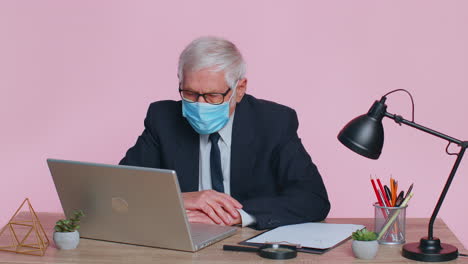 Sick-senior-businessman-wearing-medical-face-mask-coughing-suffering-from-bronchitis-asthma-allergy