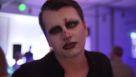 male with face paint looking up during carnival party