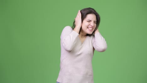 young beautiful woman covering ears from loud noise