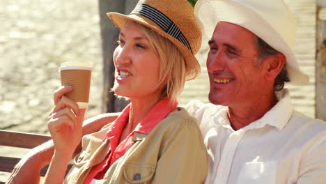 Smiling-couple-sitting-on-a-bench