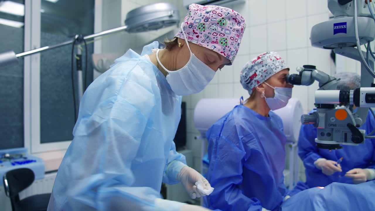 Surgeon operating patient eye. Patient and surgeon in the operating room during ophthalmic surgery