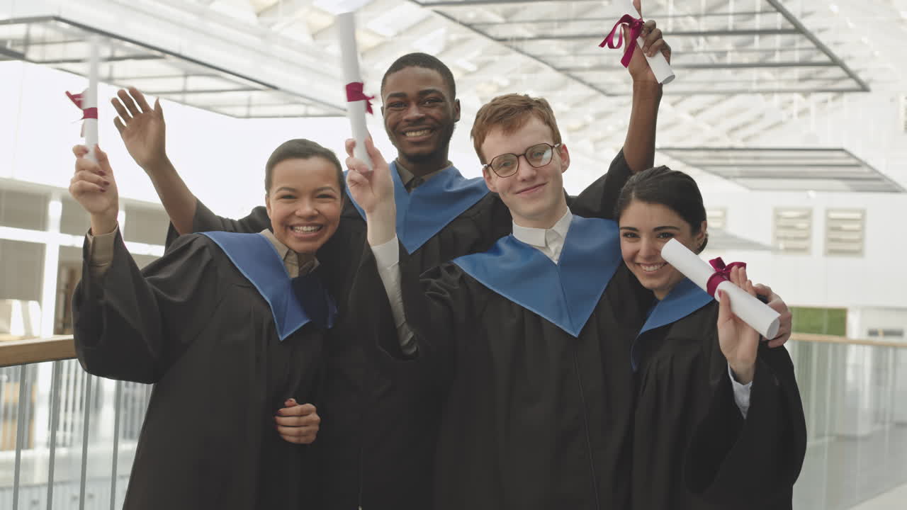 Portrait of Four Cheerful Graduates