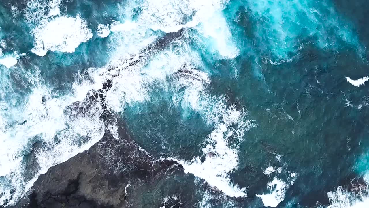 Drone aerial blue water waves Hawaii rocks
