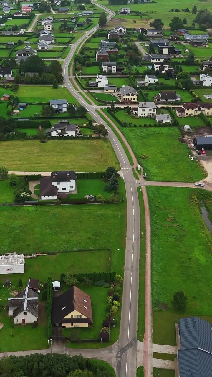 Vertical View Of Main Road Along The Residential Houses In Ikskile Town In Ogre, Vidzeme, Latvia. - aerial shot