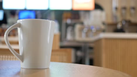 white mug on a table in a cafe