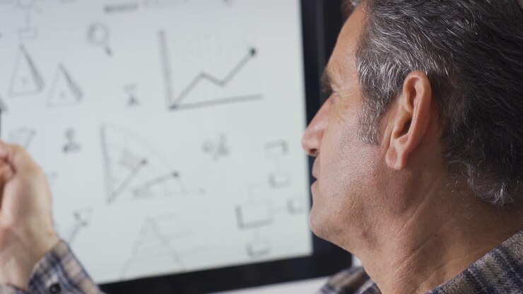 Thoughtful man over shapes on computer. He is trying to solve it.