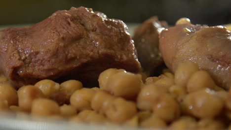 close up of cocido madrileño, traditional chickpea-based stew from madrid, spain