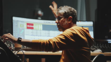 music producer directing singer during recording session