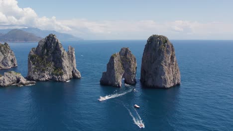 famous italy landmark of faraglioni sea stack rocks on island of capri, aerial