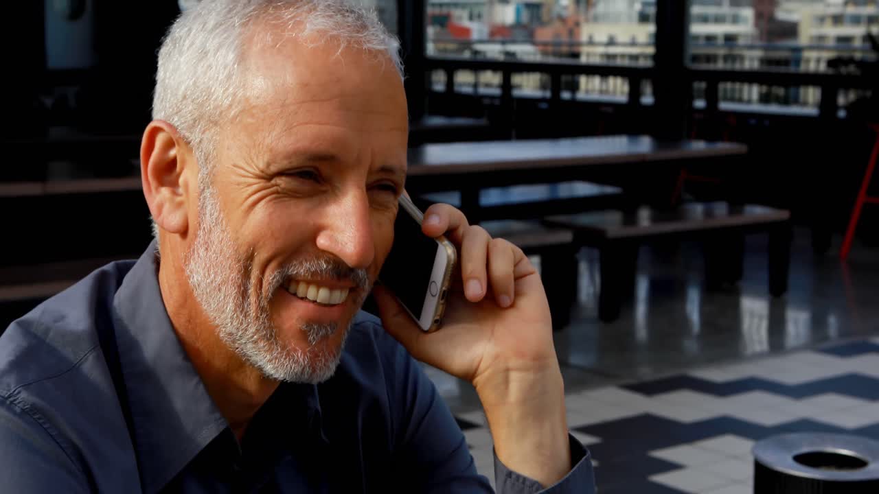 Businessman talking on mobile phone in hotel 4k