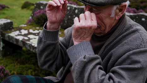 elderly man outdoors, concerned or in discomfort