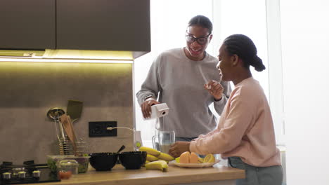 women preparing smoothie