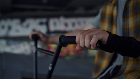 man hands holding handlebar at skate park. bmx rider getting ready for training