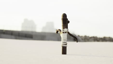 rustic water pump stands alone in an expansive landscape at dusk