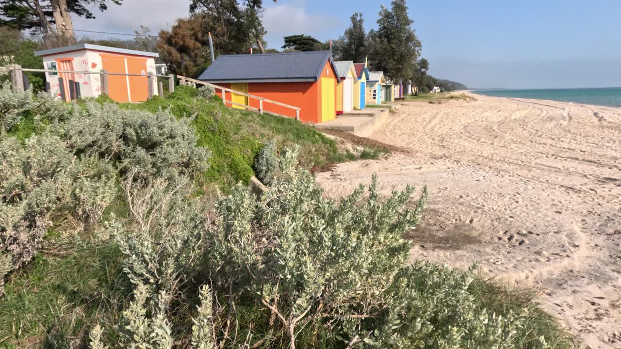 Vibrant beach boxes along sandy shore in Melbourne