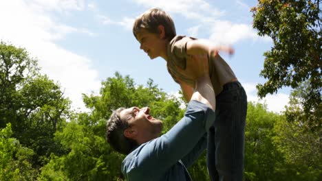 father and son playing together in the park