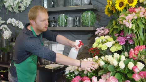 man refreshing flowers