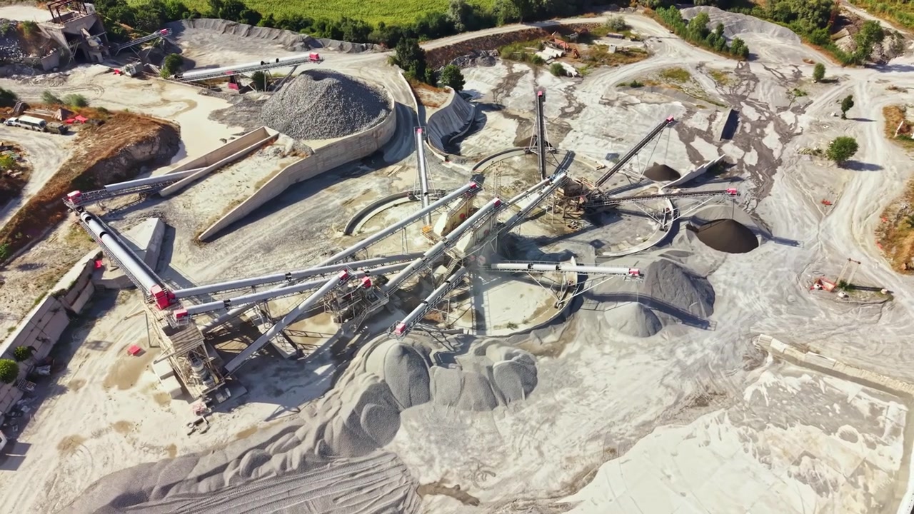 Granite quarry operation showing machinery and materials in use during daylight