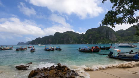 Traditional-boats-moored-on-Ton-Sai-Beach-on-Phi-Phi-Island,-Krabi-Province,-Thailand