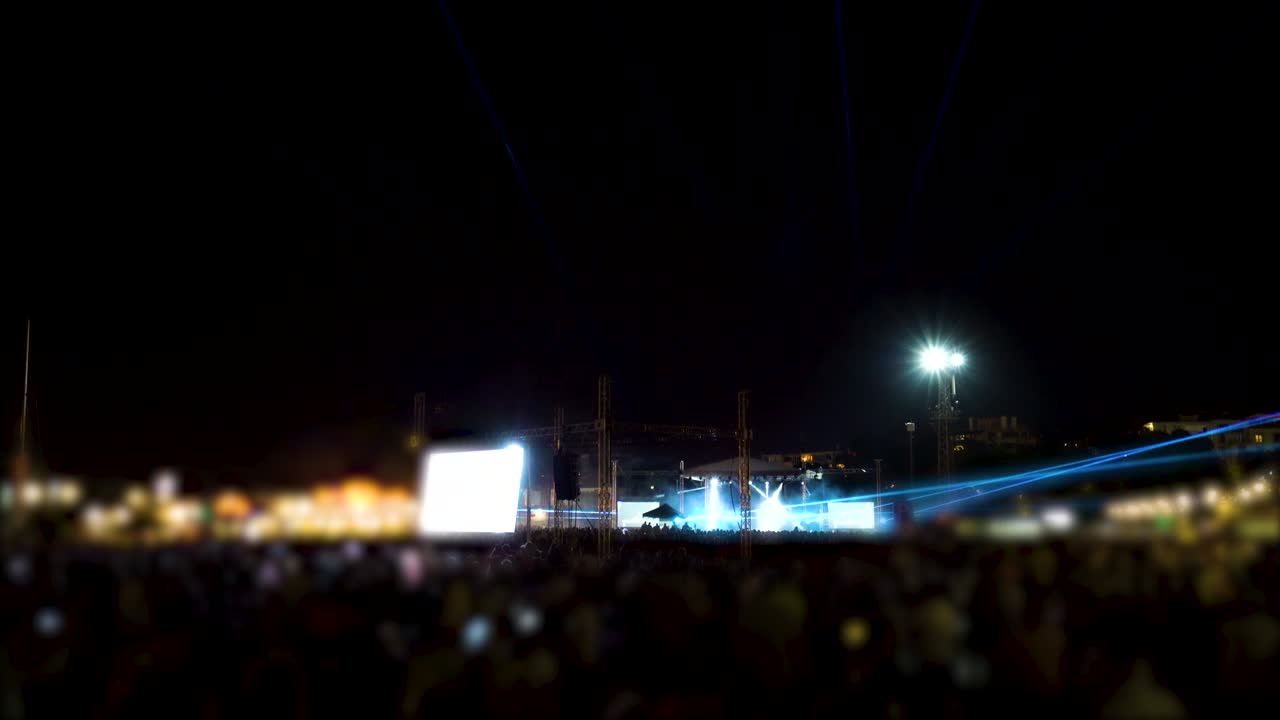 New year concert. Lights and laser performance. Happy crowd and party people