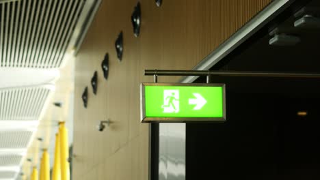 green emergency exit sign with arrow