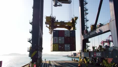 massive container crane operations at sunrise: loading and unloading procedures in an efficient dockyard environment
