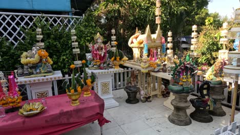 sequence of offerings at a thai spirit house