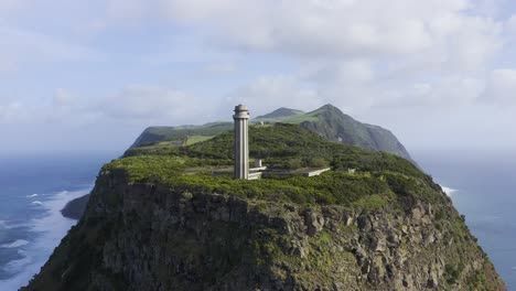 drone footage of a lighthouse on the edge of dramatic cliffs with the atlantic ocean in the background, são jorge island, the azores, portugal