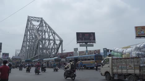bustling urban street traffic near howrah bridge in kolkata