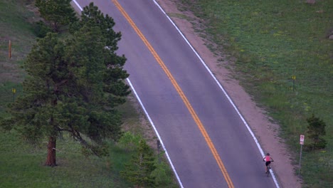 aerial view of biker climbing a mountain road