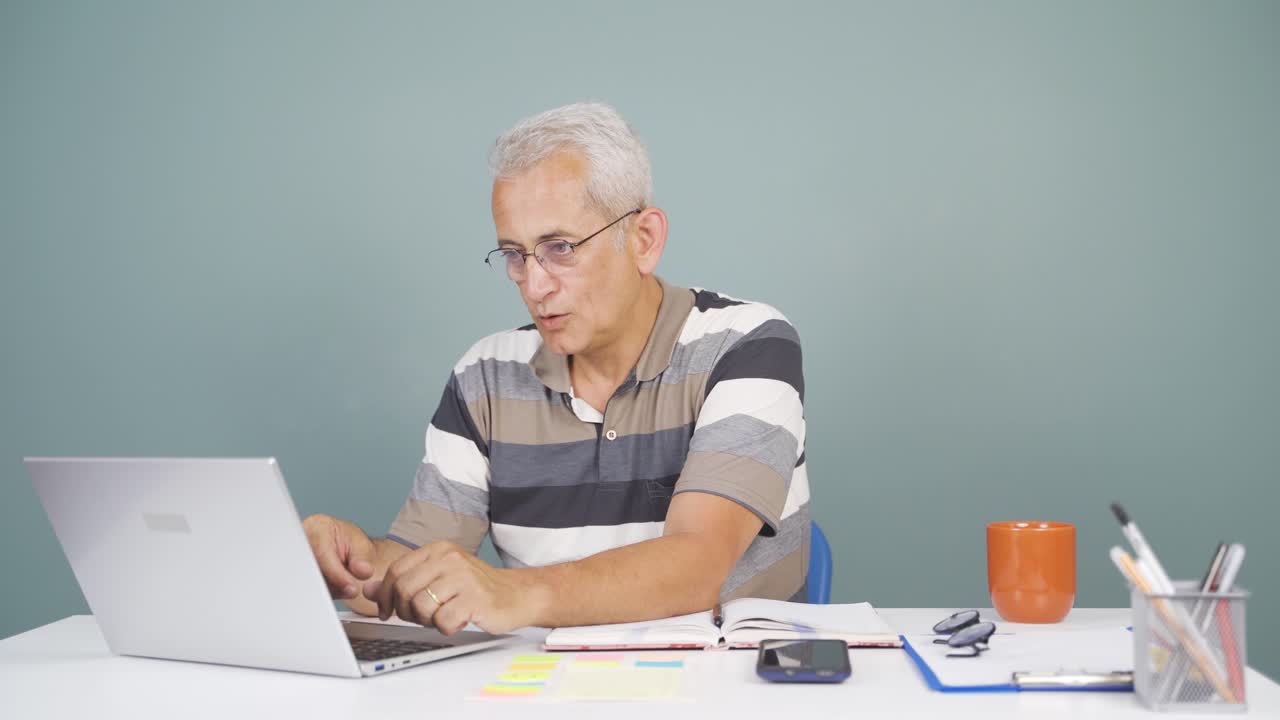 The man who likes the application on the laptop is happy.
