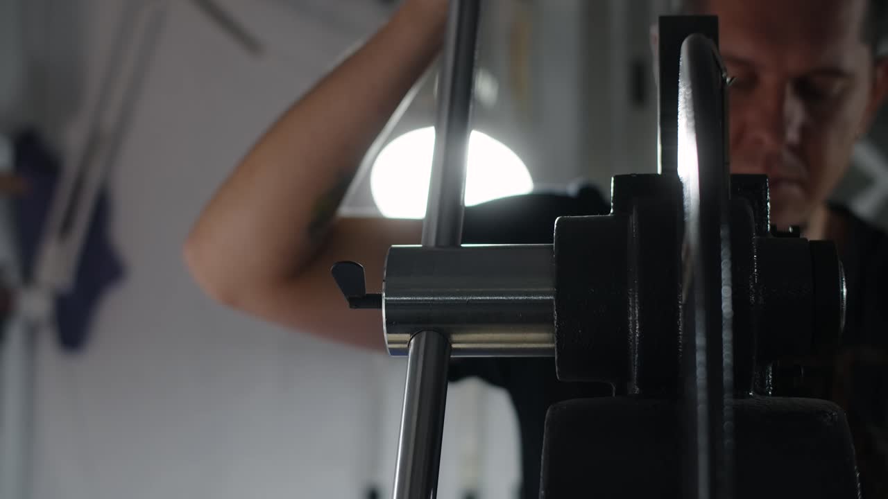 Person Adjusting a Metal Machine Part