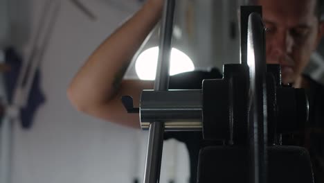 person adjusting a metal machine part