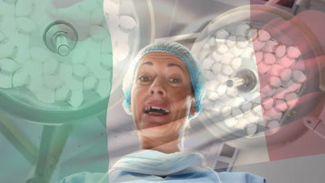 animation of flag of italy waving over female surgeon in operating theatre