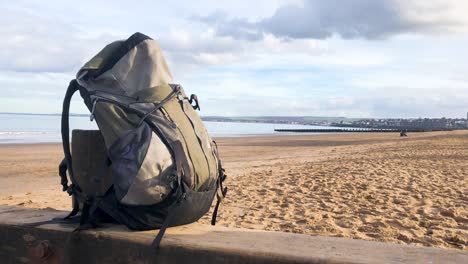 a backpack on a beach on a sunny day