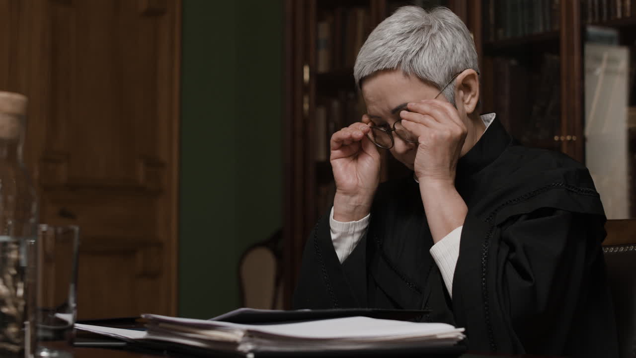 Judge Examining Documents in Library