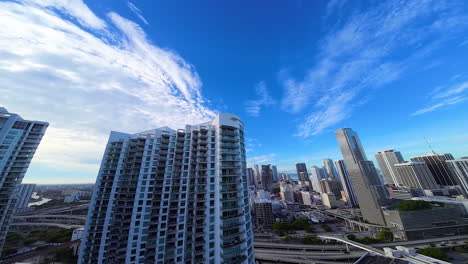 beautiful high-rise buildings in the panorama of american city. fpv drone footage above the river approaching the multi-storied house.