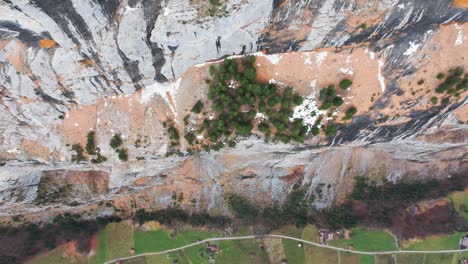 Aerial-top-down-view-of-steep-colorful-mountainside-canyon,-Switzerland