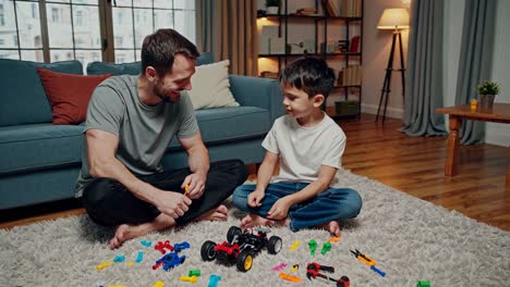 father and son building a toy car together
