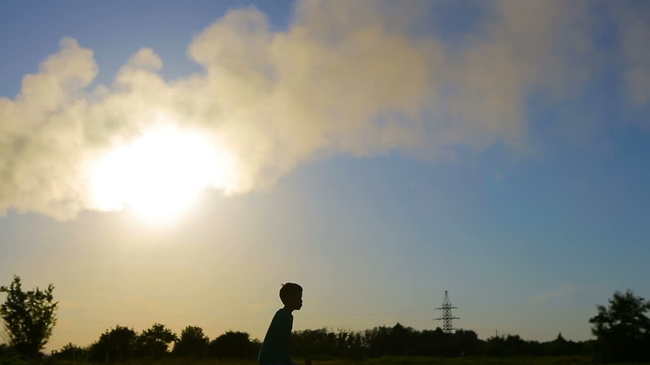 Paper Airplane In Child Hand. Happy little girl Putting a paper airplane near factory
