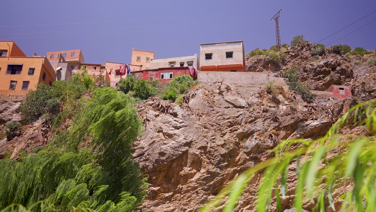 Capture the breathtaking mountain scenery in Morocco, with houses perched atop the peaks. Perfect for showcasing stunning landscapes, mountain life, and unique architectural views.