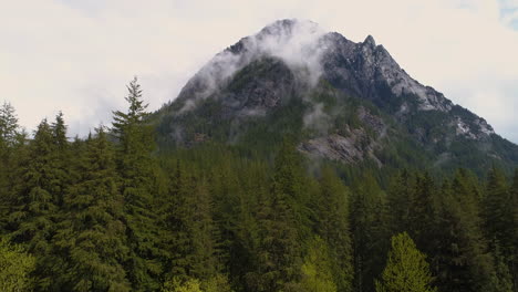 Drone-reveal-shot-of-a-cloud-covered-mountain