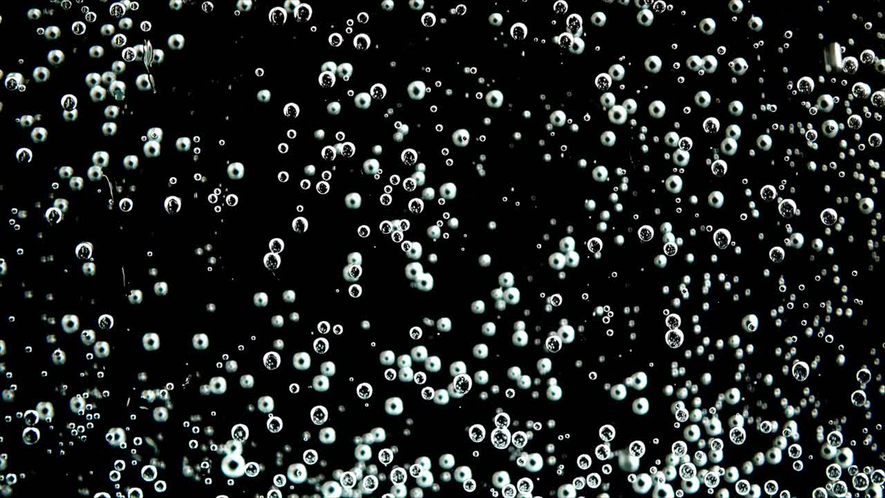 Sparkling Air Bubbles Floating on a Black Background