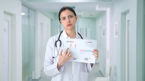 indian female doctor explaining medical reports to patient