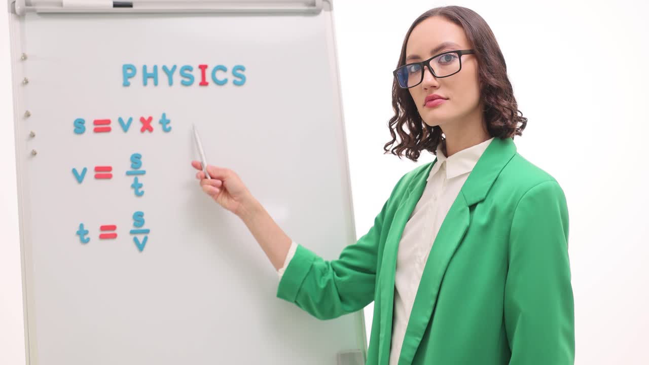 Woman Teaching Physics Formulas on Whiteboard