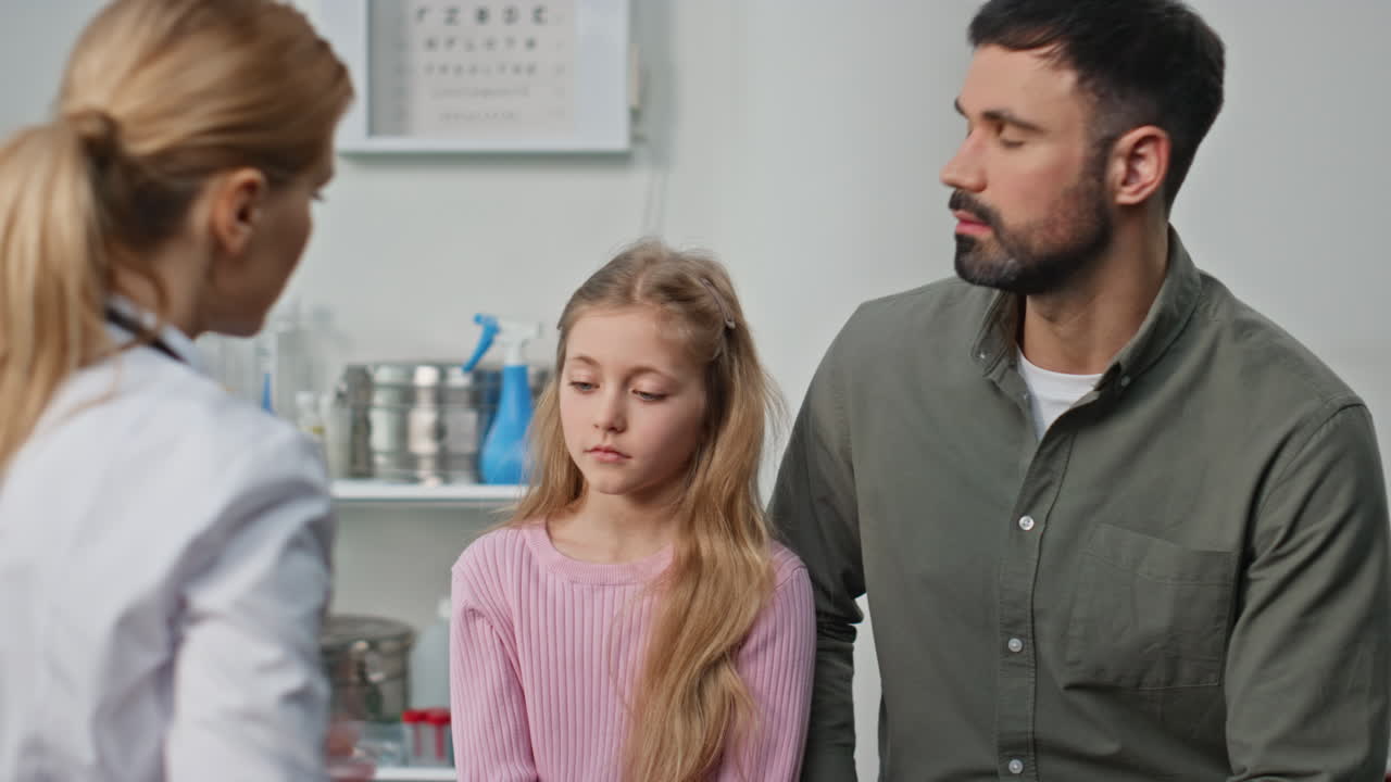 Ill girl visiting clinic doctor with parent closeup. Pediatrician measuring body