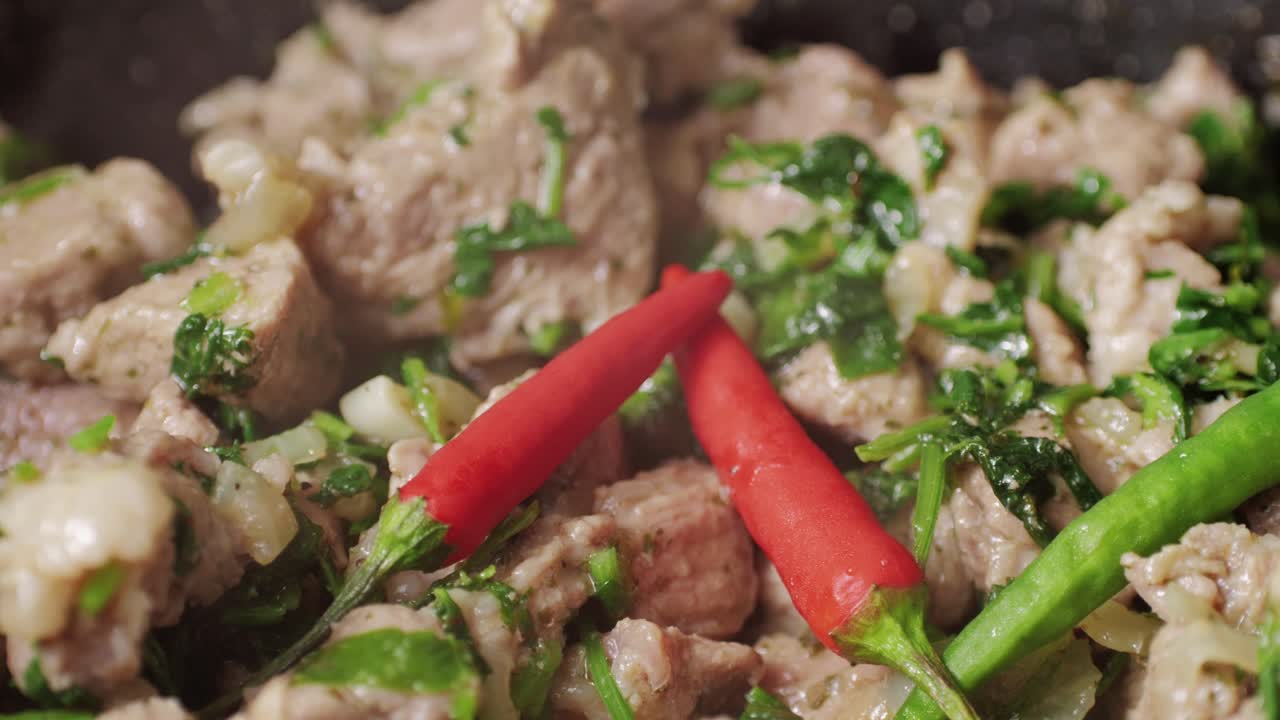 Chicken or pork stew with red and green pepper onion, and spices cooking in a frying pan. Traditional mexican cuisine, tacos preparation, ragout.