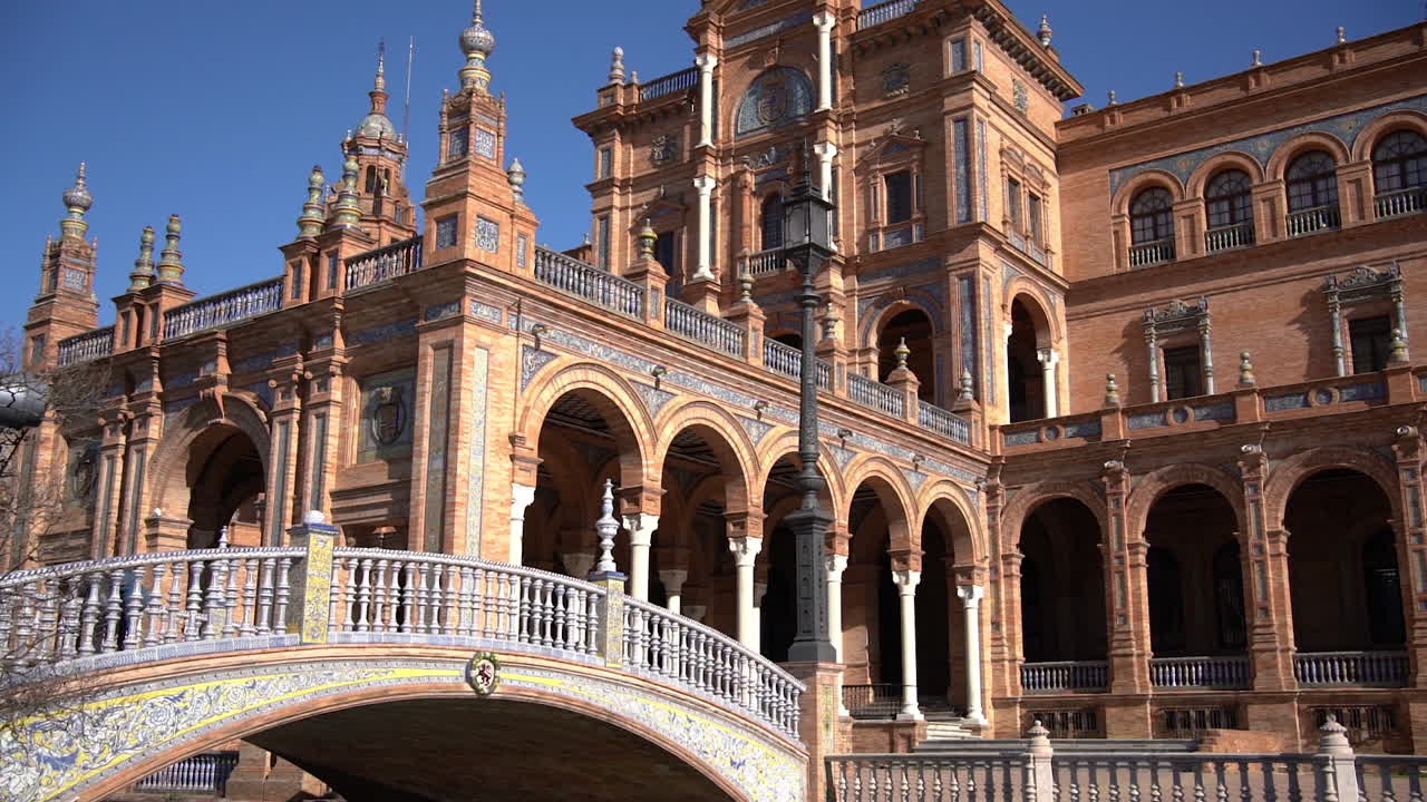 Famous Plaza de Espana, Seville, Spain.  Bridge and Historic Buildings on Sunny Day During Covid-19 Virus Pandemic, Tilt Up